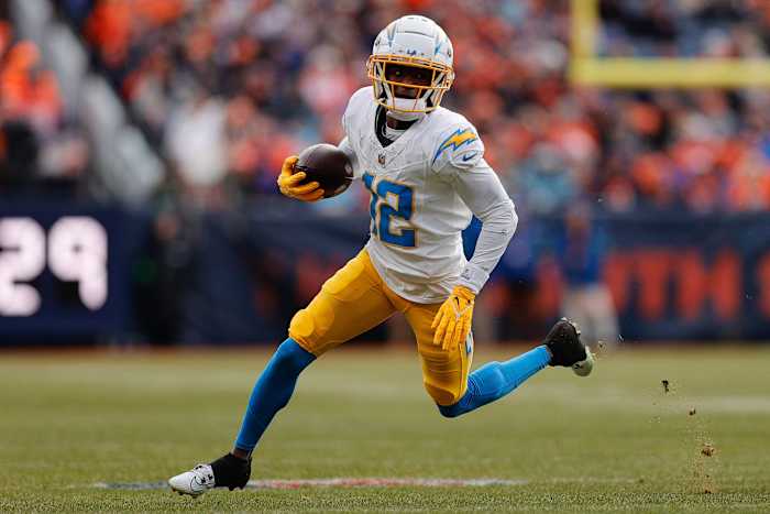 Dec 31, 2023; Denver, Colorado, USA; Los Angeles Chargers wide receiver Derius Davis (12) runs the ball in the second quarter against the Denver Broncos at Empower Field at Mile High. Mandatory Credit: Isaiah J. Downing-USA TODAY Sports